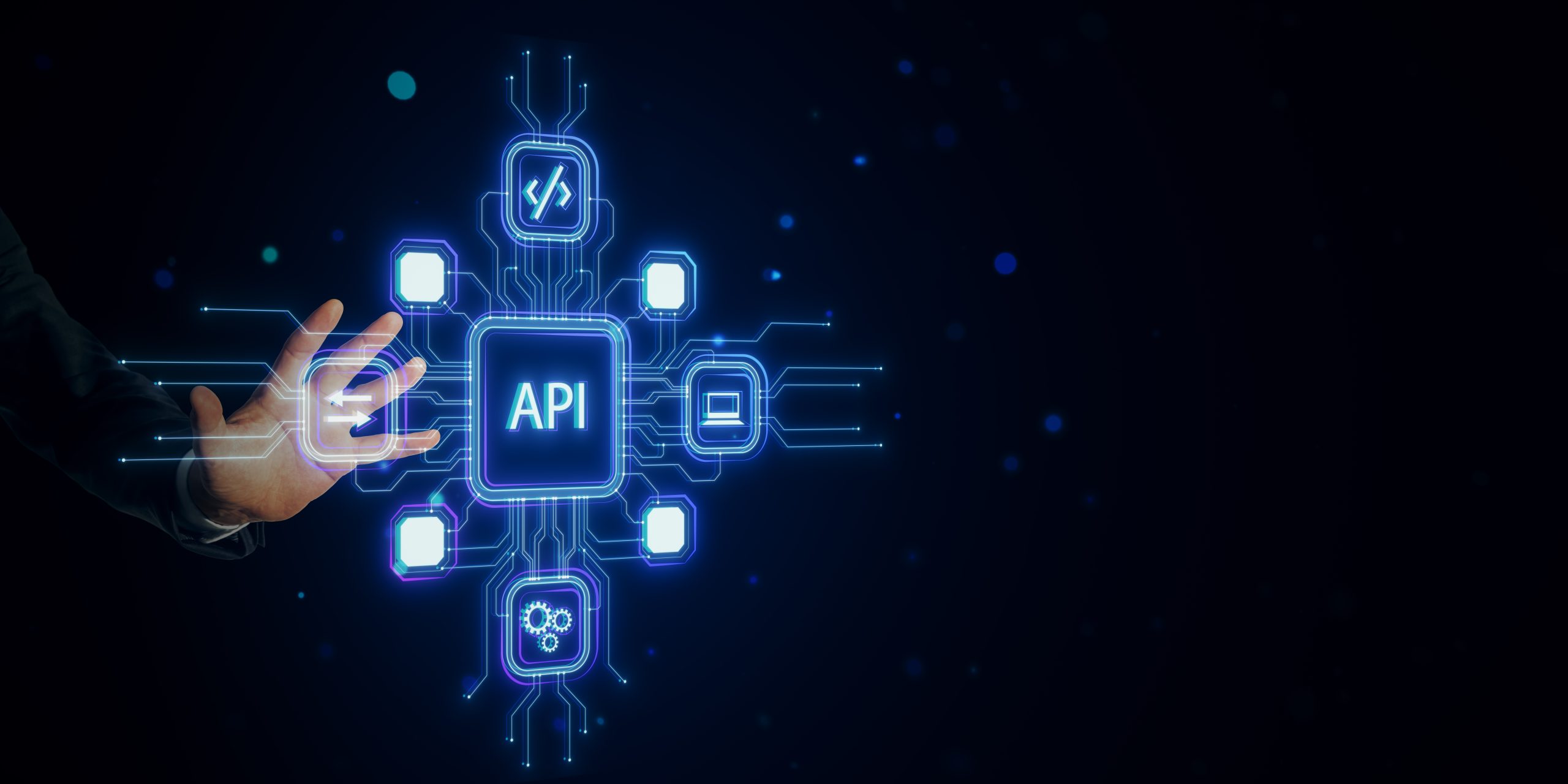 Desarrollo de APIs e Integraciones A hand interacts with holographic API icons connected through lines, glowing on a dark blue background. Concept of online software and technology network